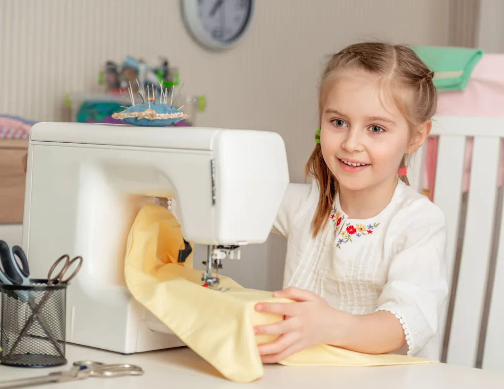 criança costurando em máquina de costura